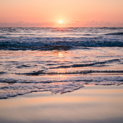 Rising Sun Reflected in Ocean Waves