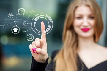 A young businesswoman holds e-commerce icons. The concept of the Internet, technology, business, communication and management