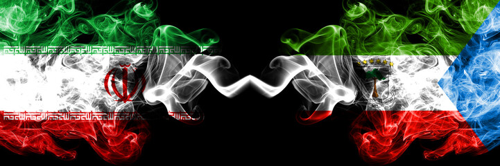 Iran vs Equatorial Guinea smoky mystic states flags placed side by side. Thick colored silky smokes flag combination of Iranian and Equatorial Guinea