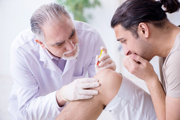 Male patient visitng doctor for shot inoculation 