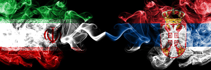Iran vs Serbia, Serbian smoky mystic states flags placed side by side. Thick colored silky smokes flag combination of Iranian and Serbia, Serbian