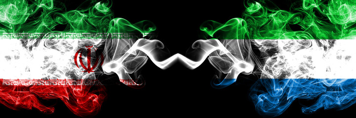 Iran vs Sierra Leone smoky mystic states flags placed side by side. Thick colored silky smokes flag combination of Iranian and Sierra Leone