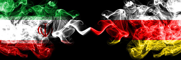 Iran vs South Ossetia smoky mystic states flags placed side by side. Thick colored silky smokes flag combination of Iranian and South Ossetia