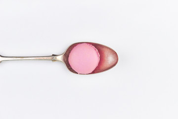 pink light macaron in vintage silver gold spoon sweet dessert flatlay top view