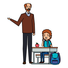student boy seated in school desk with male teacher