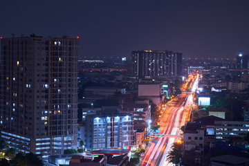 Fototapeta na wymiar cityscape night view with light tail on street by traffic car