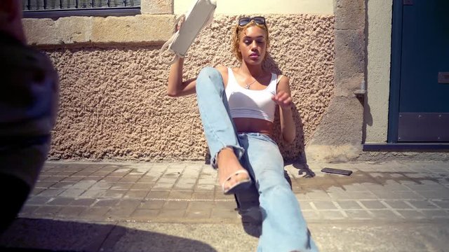 Beautiful sexy transsexual model in the modern city. she is sitting