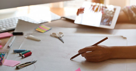 Female fashion designer using tablet for new trend