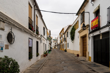 Fototapeta na wymiar Walking down a typical Spanish town residential street of Cordoba and a great example of the Pueblo Blanco (White Village) areas in Andalucia