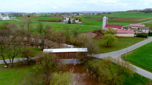 Bitzer's mill covered bridge in Lancaster county, Pennsylvania, aerial view of American rural landscape and wooden bridge across river, travel and landscape