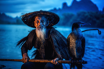 Cormorant fisherman in Traditional showing of his birds on Li river near Xingping, Guangxi...