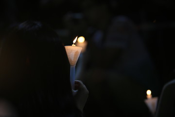 finding the light in dark. a haza candlelight vigil find each other in darkness, blur background in hong kong victoria park in 64 anniversary