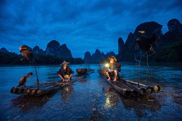 Cormorant fisherman in Traditional showing of his birds on Li river near Xingping, Guangxi...