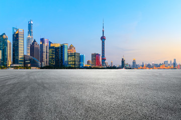 Asphalt race track and modern skyline and buildings in Shanghai at sunset