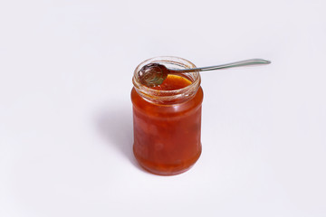 Glass jar of jam on a dark background