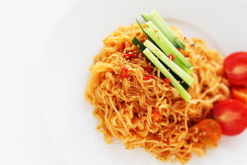 Asian food, mixed ramen noodles served with cucumber 