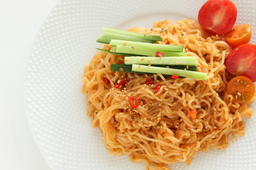 Asian food, mixed ramen noodles served with cucumber 