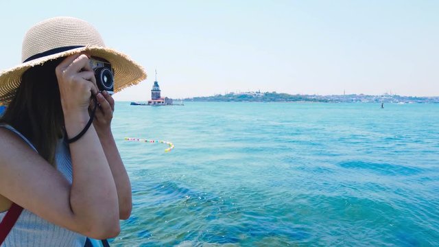 Slow motion:Beautiful girl takes pictures of Bosphorus,a popular destination in Uskudar town,Istanbul,Turkey