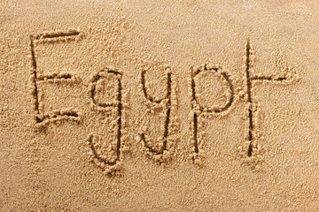 Egypt word written in sand on a sunny egyptian summer beach holiday vacation travel destination sign writing message photo