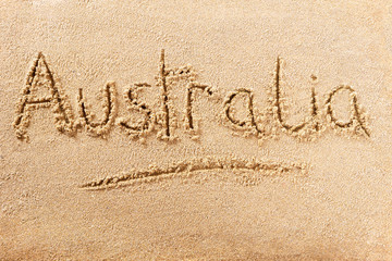 Australia word written in sand on a sunny australian summer beach holiday vacation travel destination sign writing message photo