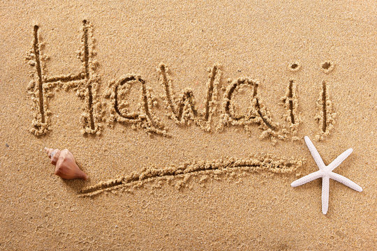 Hawaii word written in sand on a sunny summer beach with starfish holiday vacation travel destination sign writing message photo