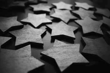 Wooden stars on the table. The texture of the stars. Black and white photo with stars