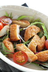 Asian food, fish cake and baby leaf salad