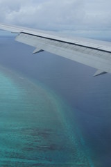Naklejka premium View from the window of the plane to the Maldives with airplane's wing