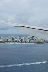 View from the window of the plane to the Maldives with airplane's wing