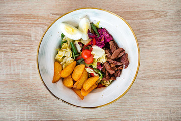 salad with baked potatoes and beef