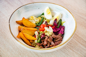 salad with baked potatoes and beef