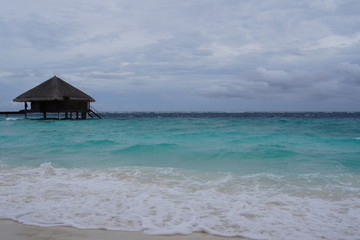 Water villa, cloudy sky and the Indian Ocean in cloudy weather