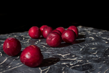 Fresh plums on a black background.