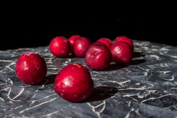 Fresh plums on a black background.
