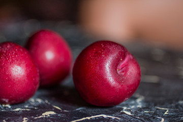 Fresh plums on a black background.