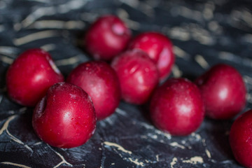 Fresh plums on a black background.