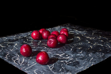 Fresh plums on a black background.