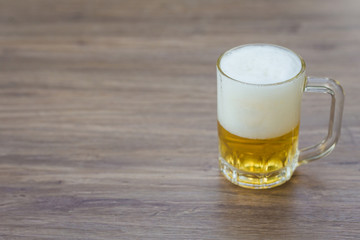 Beer in glass on wooden table