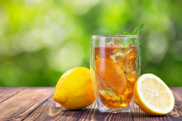 glass of ice tea on wooden table