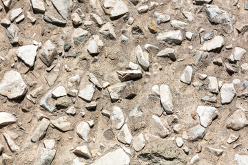 Stone rubble in the concrete wall as background