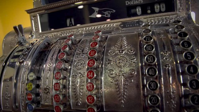 This video is a panning video of an authentic antique cash register.