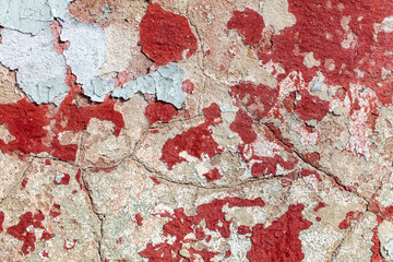 Concrete wall with cracked paint as abstract background