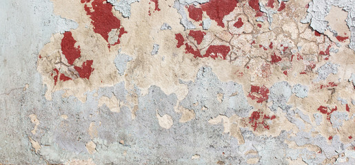 Concrete wall with cracked paint as abstract background