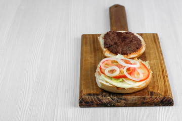 Ground beef burger with tomato, onion and lettuce, homemade.