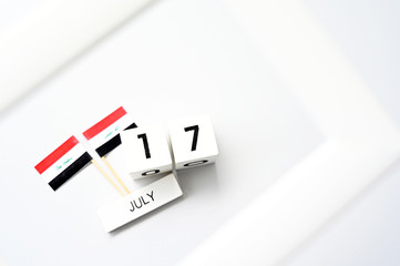 July 17 Wooden calendar and Iraq Flag Concept Iraq national day