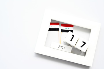 July 17 Wooden calendar and Iraq Flag Concept Iraq national day