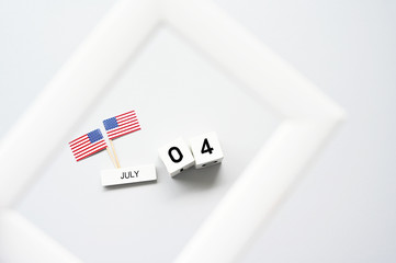 Fototapeta na wymiar 4th of July calendar and American Flag in picture frame Concept Happy Independence Day