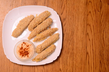 Pile of breaded crab sticks isolated