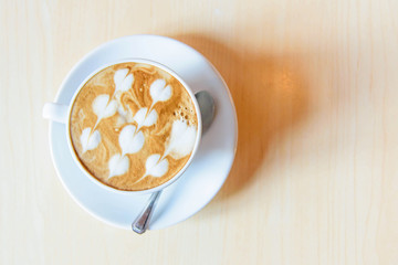 hot cappuccino with nice milk pattern in paw and coffee bean heart shape / coffee with love 