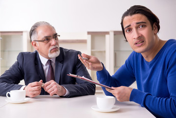 Male real estate agent and male client in the apartment 